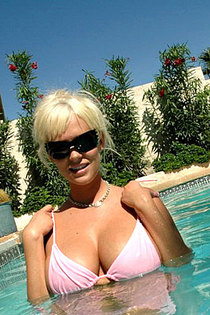 Blonde pornstar is sunbathing naked after swimming in the pool-14